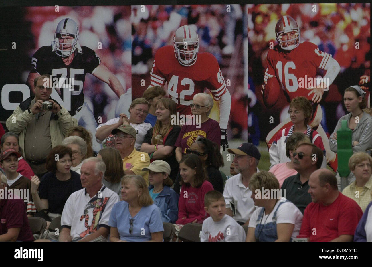 With posters of fotball greats Howie Long of the Raiders, and Ronnie Lott and Joe Montana of the 49ers, fans line Cleveland St in downtown Canton, OH 7/29/00 am to see them parade by in a parade, attended by thousands, honoring the Hall of Fame inductees.(Sac Bee/Chris Crewell)  /ZUMA Press Stock Photo