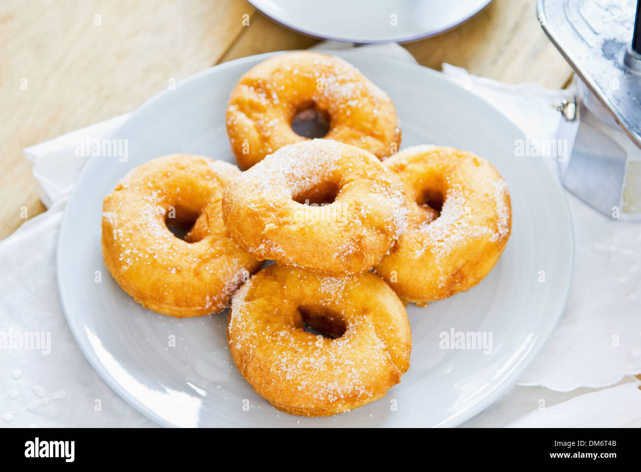 Donuts with sugar in a dish by coffee Stock Photo Alamy