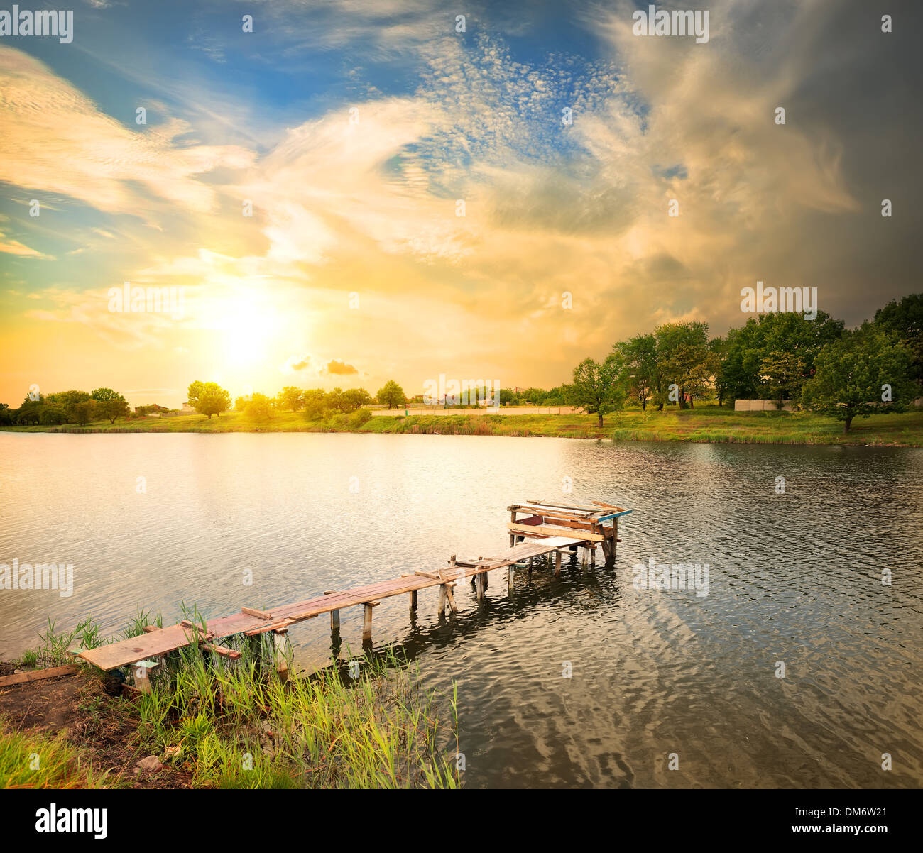 Wooden dock, pier, on a lake in the evening Stock Photo