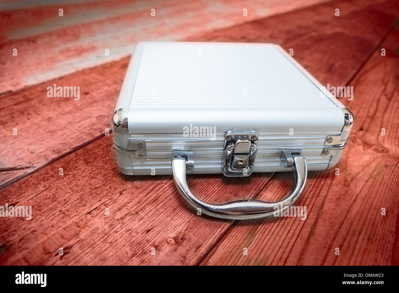 Steel briefcase laying on the red floor Stock Photo - Alamy