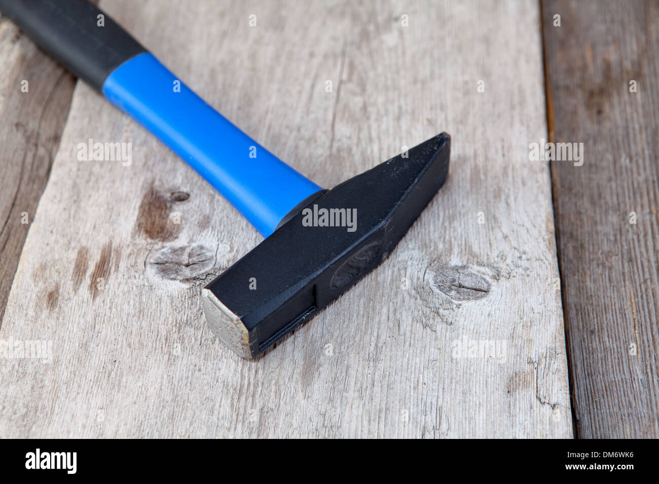 Modern hammer laying on hardwood floor Stock Photo Alamy
