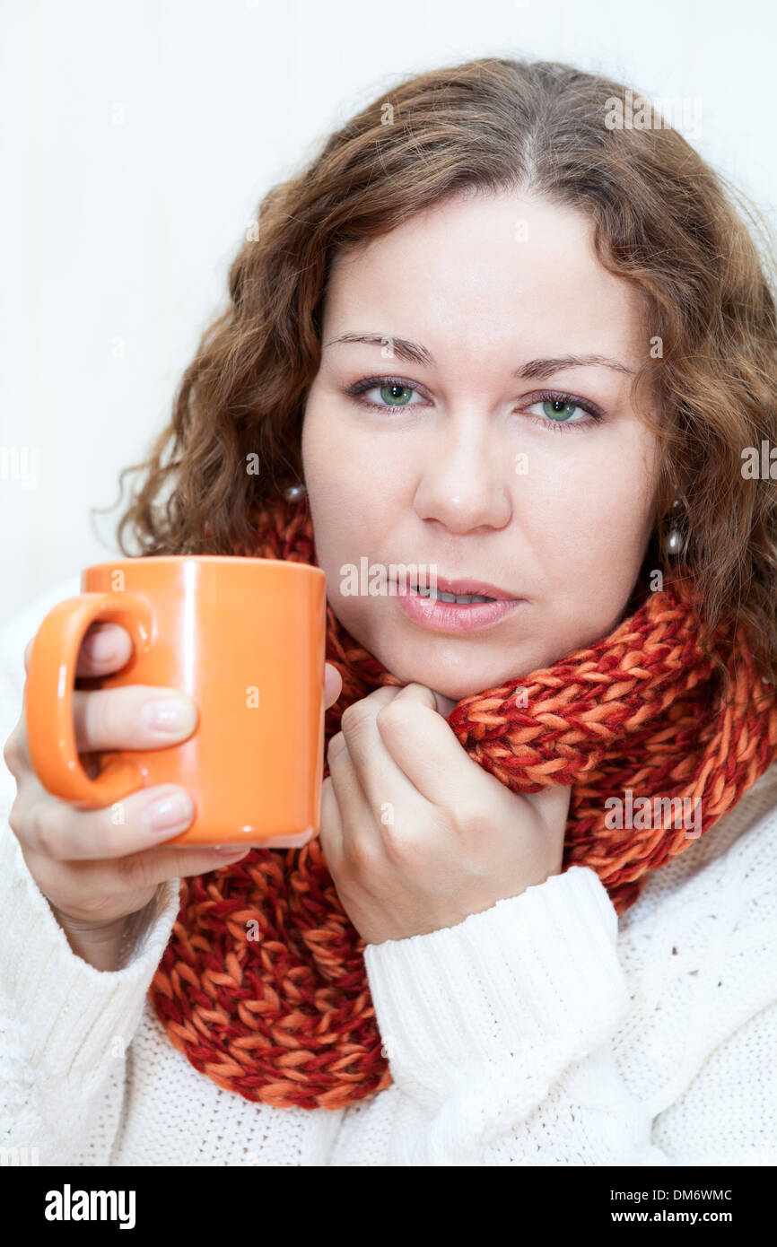 Caught a cold woman with a hot cup of tea in hands Stock Photo