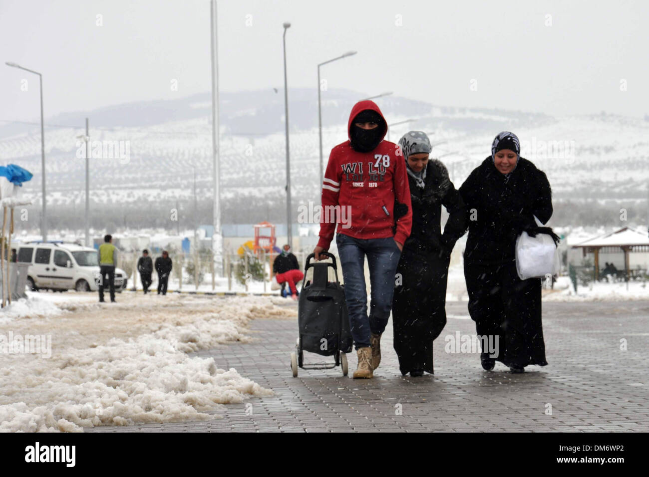 Kilis, Turkey. 12th Dec, 2013. Syrian refugees are seen at a refugee camp in Kilis province, Turkey, Dec. 12, 2013. Heavy snowfall across Turkey hit Syrian refugee camps in Kilis as well. Credit:  Mert Macit/Xinhua/Alamy Live News Stock Photo