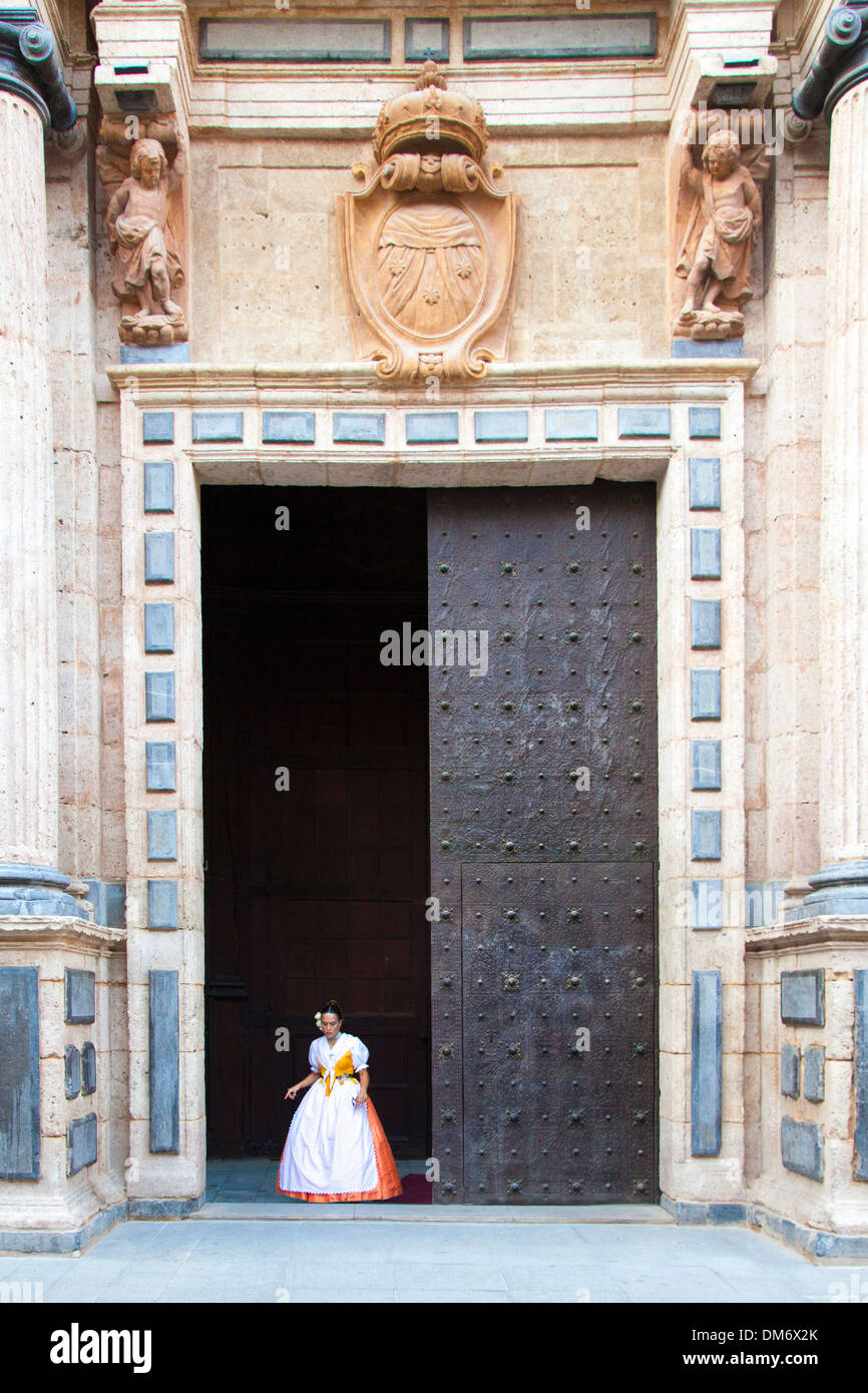 Woman in traditional dress coming out of Iglesia y Convento del Carmen, Valencia, Spain. Stock Photo