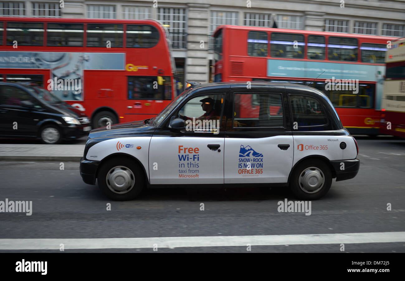 London, Great Britain. 19th Nov, 2013. A London cap advertising free wireless internet access drives past two red double-decker buses in London, Great Britain, 19 November 2013. Photo: Andreas Gebert/dpa/Alamy Live News Stock Photo