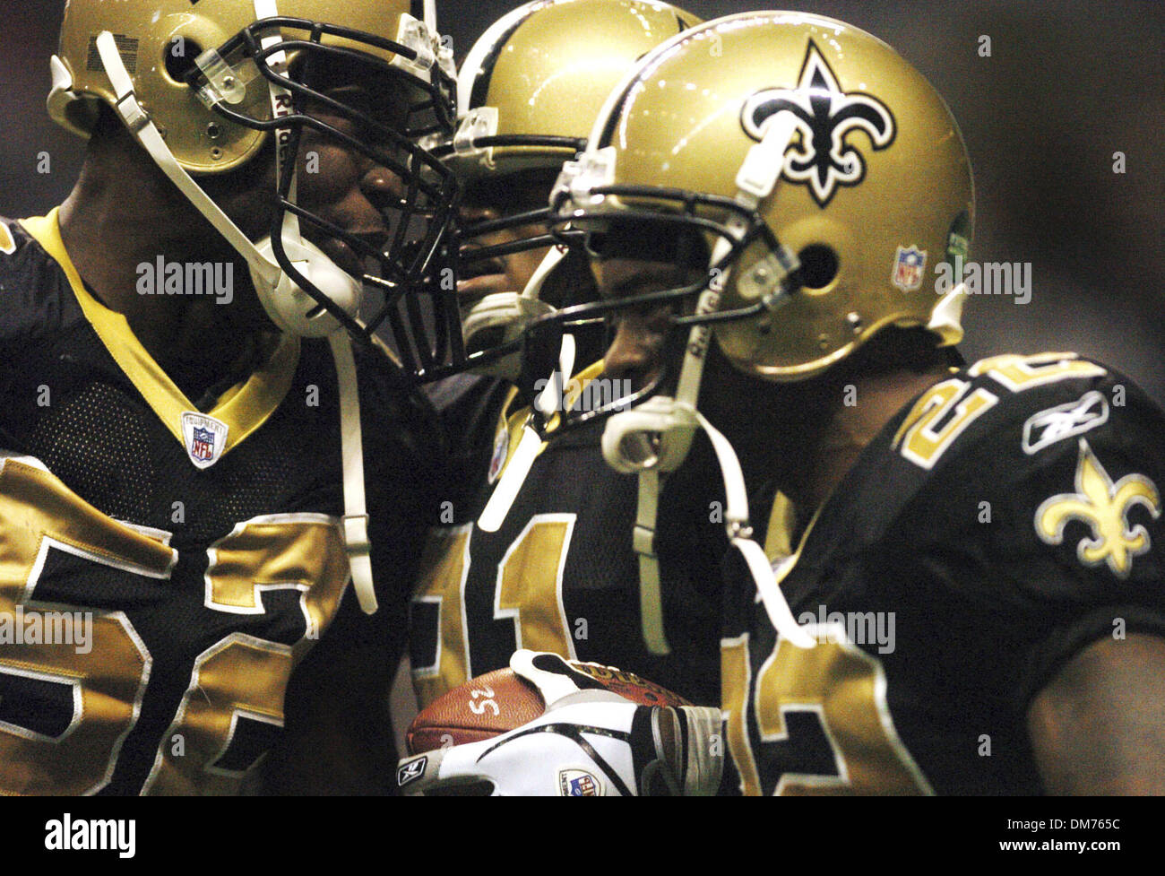 Oct 02, 2005; San Antonio, TX, USA; NFL Football: New Orleans Sains cornerback Jason Craft, middle, is congratulated by teammates Sedrick Hodge, left, and Fred Thomas, right after intercepting a pass during NFL action against the Buffalo Bills in the Alamodome on Sunday. The Saints lost the use of their home stadium, the Superdome, when Hurricane Katrina ravaged New Orleans on Aug. Stock Photo