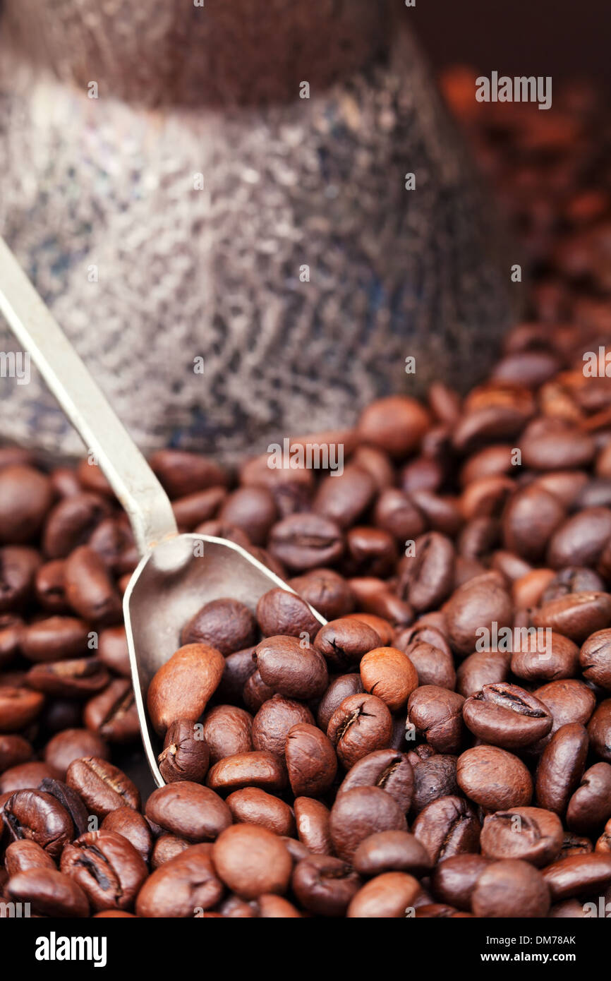 spoon scoops roasted coffee beans and copper coffee pot close up Stock Photo Alamy
