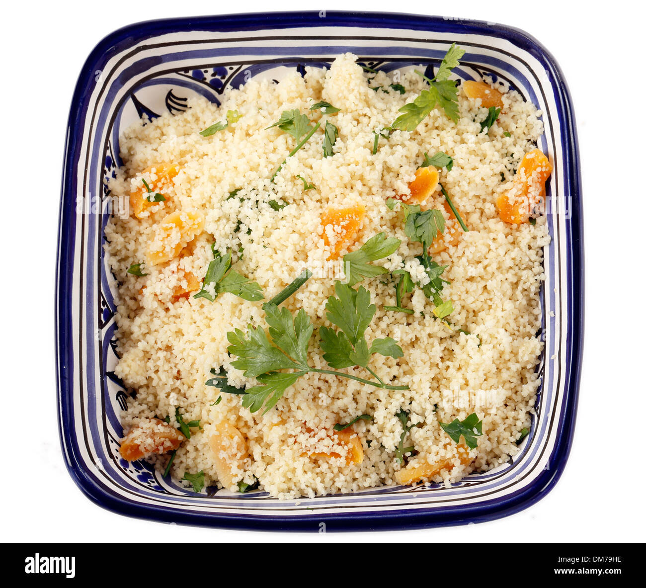 couscous mixed with chopped dried apricots and fresh parsley in a blue