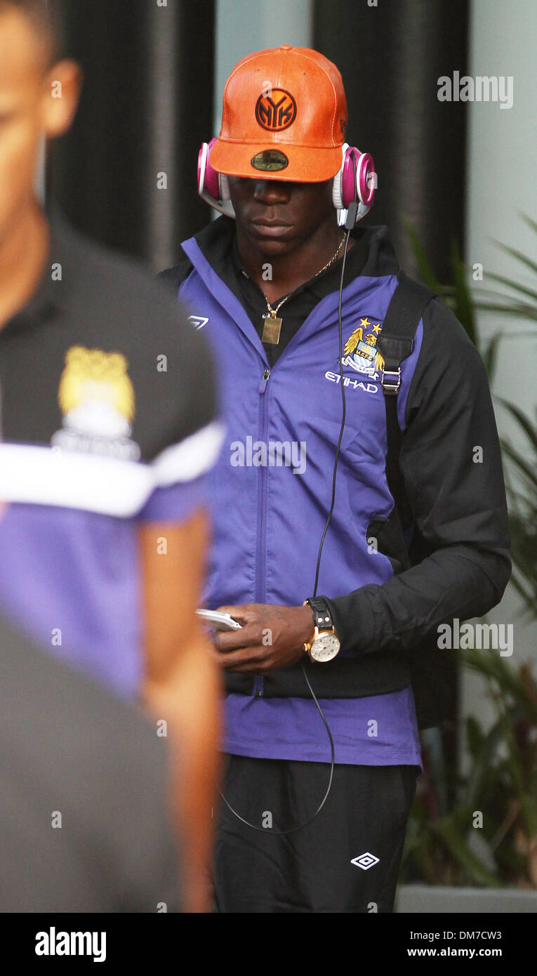 Mario Balotelli leaving a hotel in Liverpool wearing pink Beats By Dre  headphones and a bright orange baseball cap Liverpool Stock Photo - Alamy