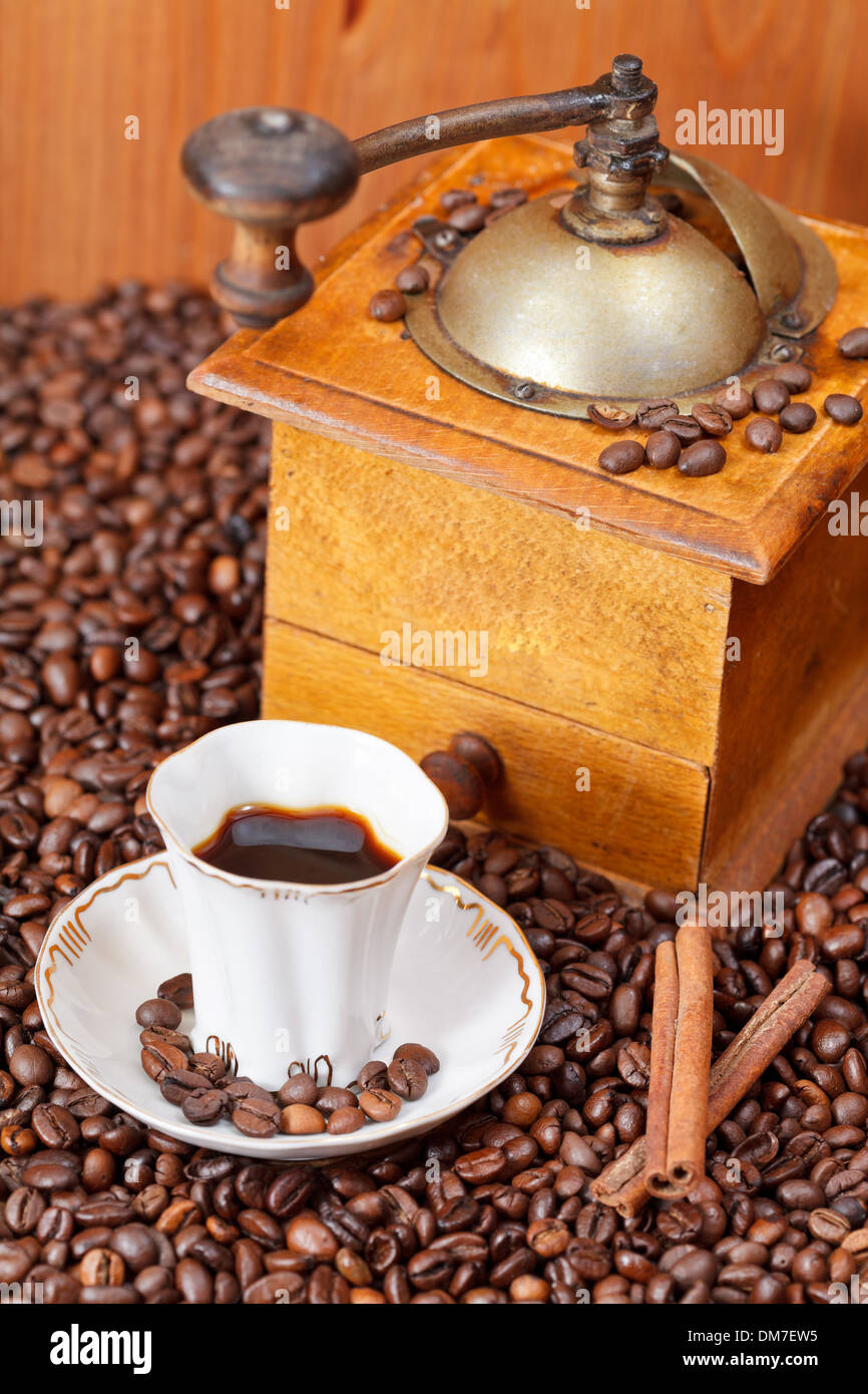 small cup of coffee and roasted coffee beans with retro wood manual