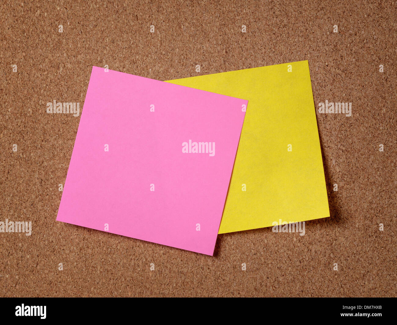 two reminder sticky notes on cork board, empty space for text Stock Photo