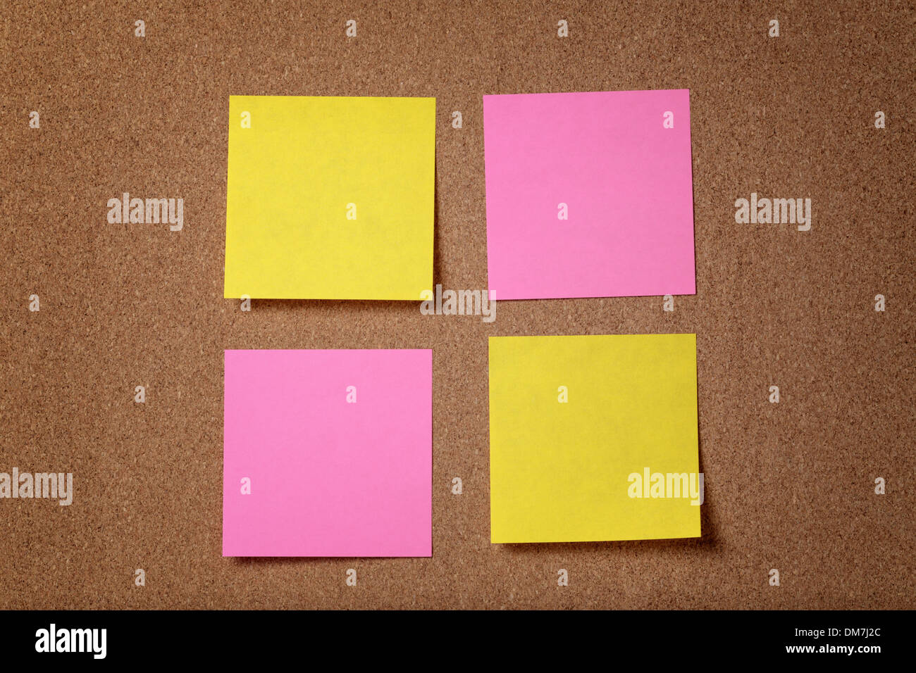 four reminder sticky notes on cork board, empty space for text Stock Photo