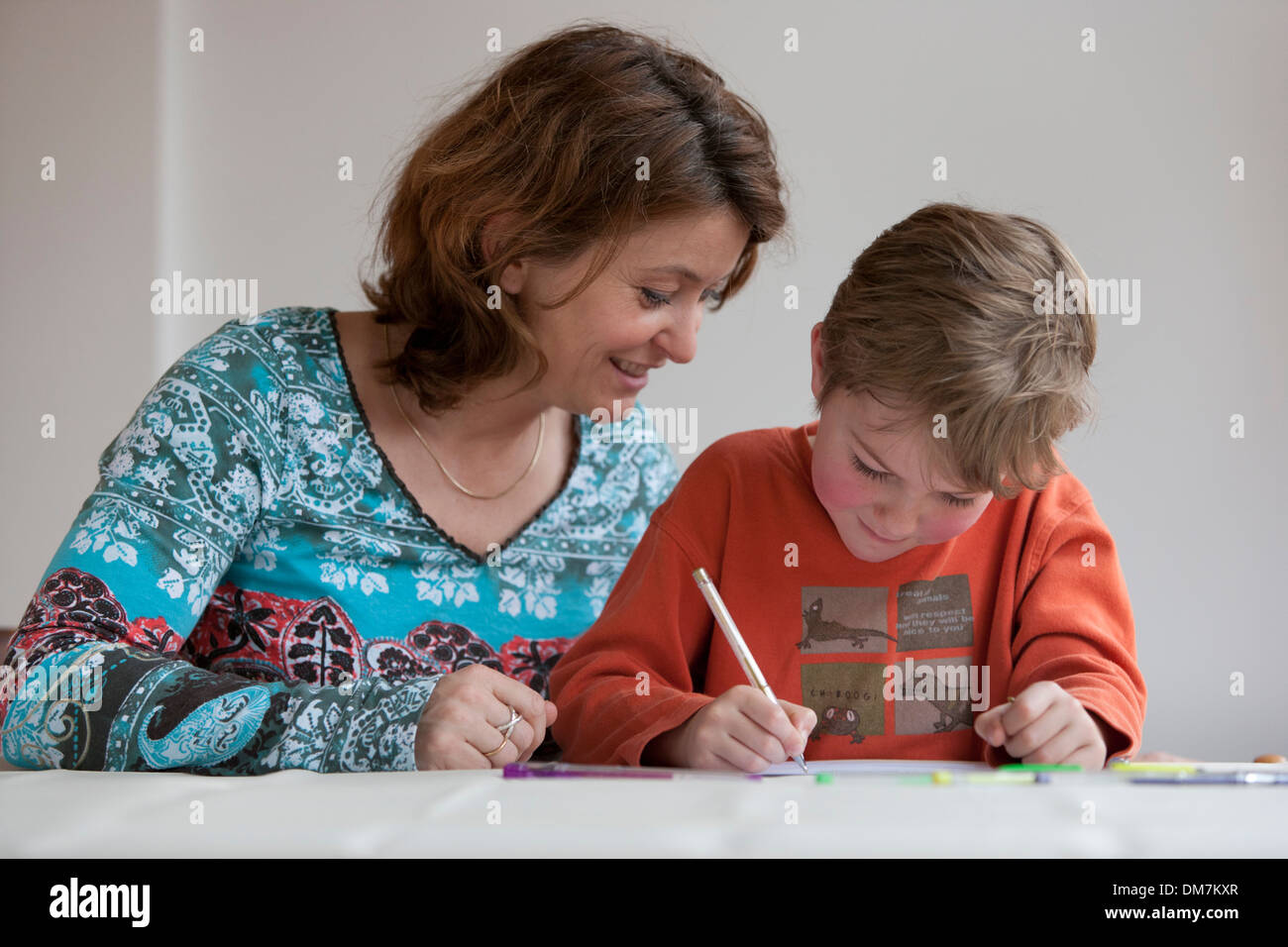Mother and son making homework at home Stock Photo - Alamy