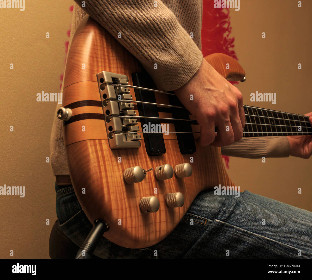 Man sitting and playing a bass guitar (Series with the same model
