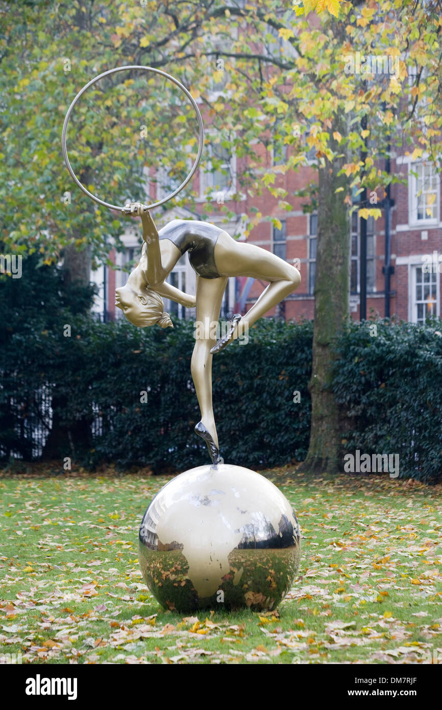 Golden Statue of A Ballet Dancer With a Hoop Dancing on top of the World London England Stock Photo