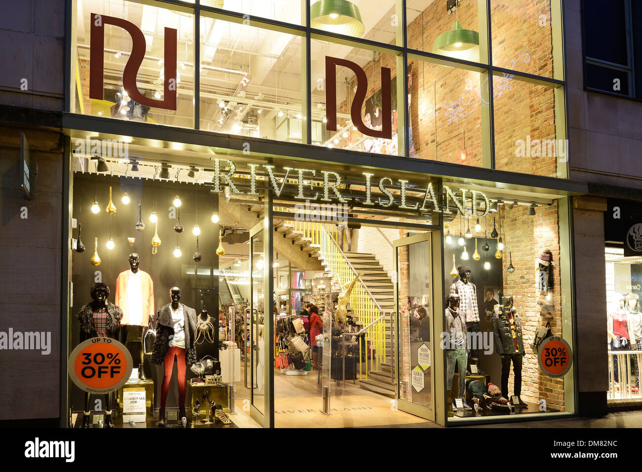 Exterior of a River Island shop unit at night in Oxford city centre Stock Photo