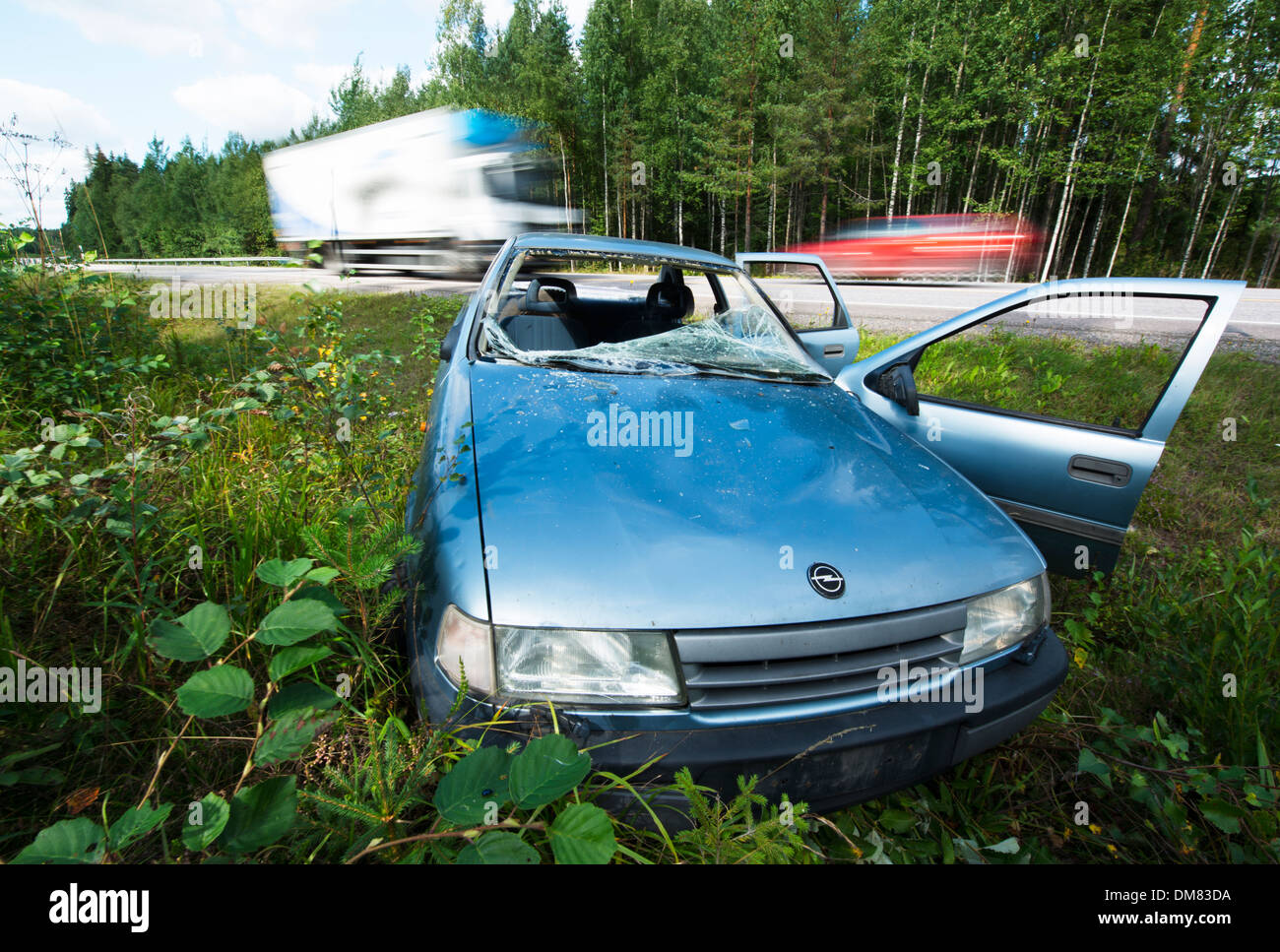 Wrecked car on the side of a road after an accident Stock Photo