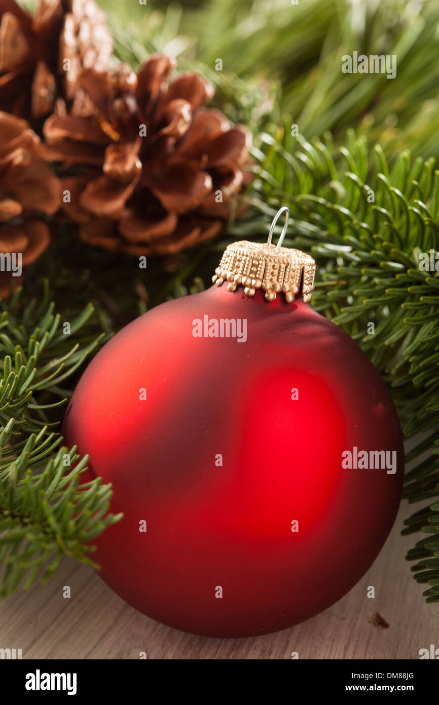 Festive Red Christmas Ornament with Green Garland Stock Photo - Alamy