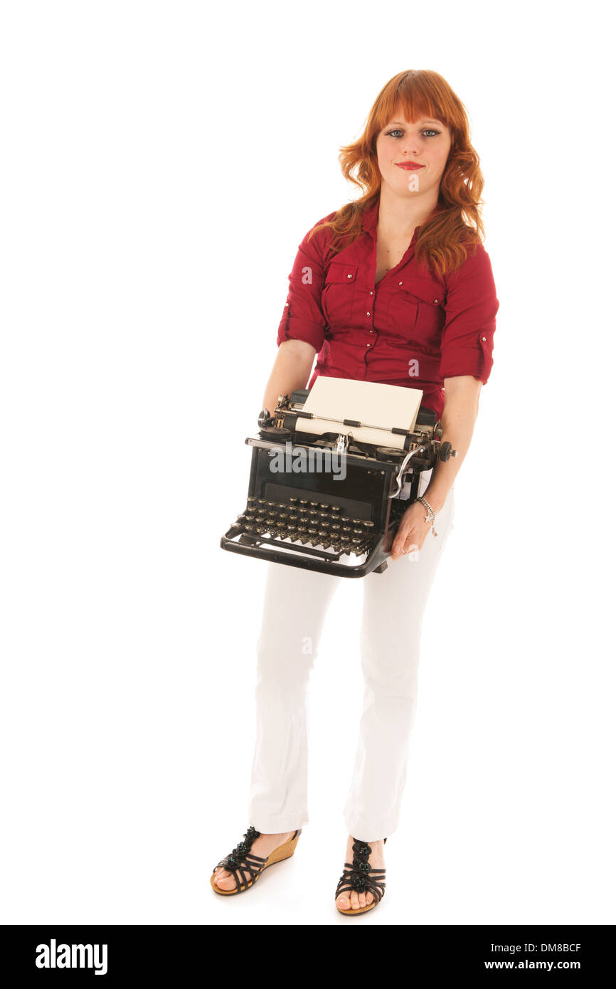 Woman is carrying a heavy vintage black typewriter Stock Photo