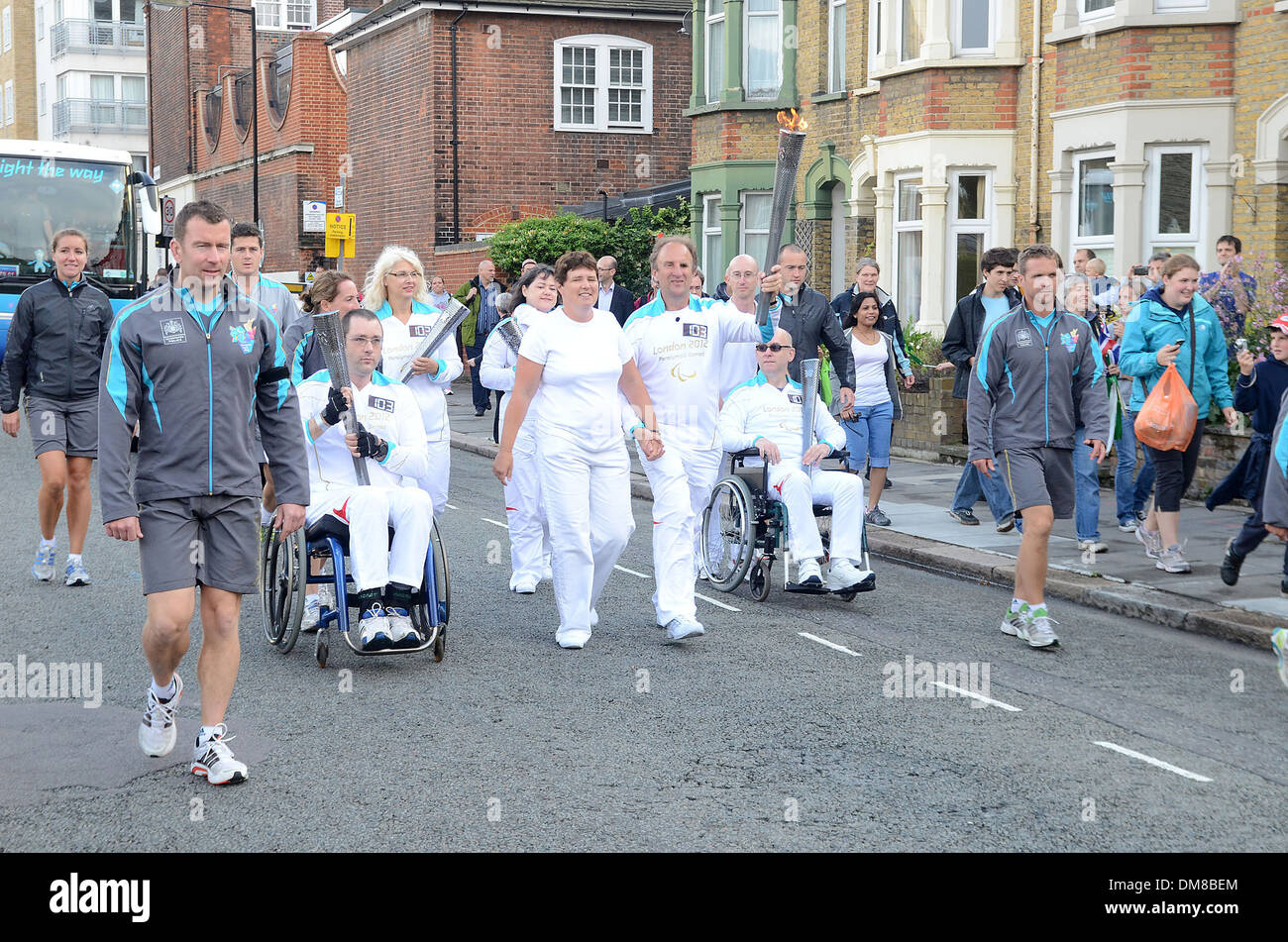 Torchbearers with the Paralympic flame on The Isle Of Dogs. London, England - 29.08.12 Stock Photo