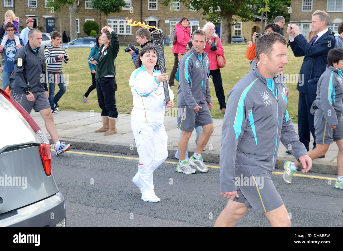 Torchbearers with the Paralympic flame on The Isle Of Dogs. London, England - 29.08.12 Stock Photo