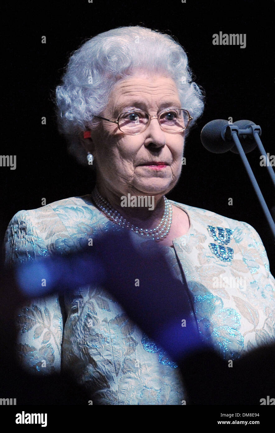 Queen Elizabeth II wearing ear plugs officially opens the London