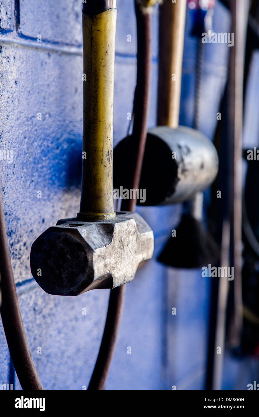 Hammer hanging on wall Stock Photo