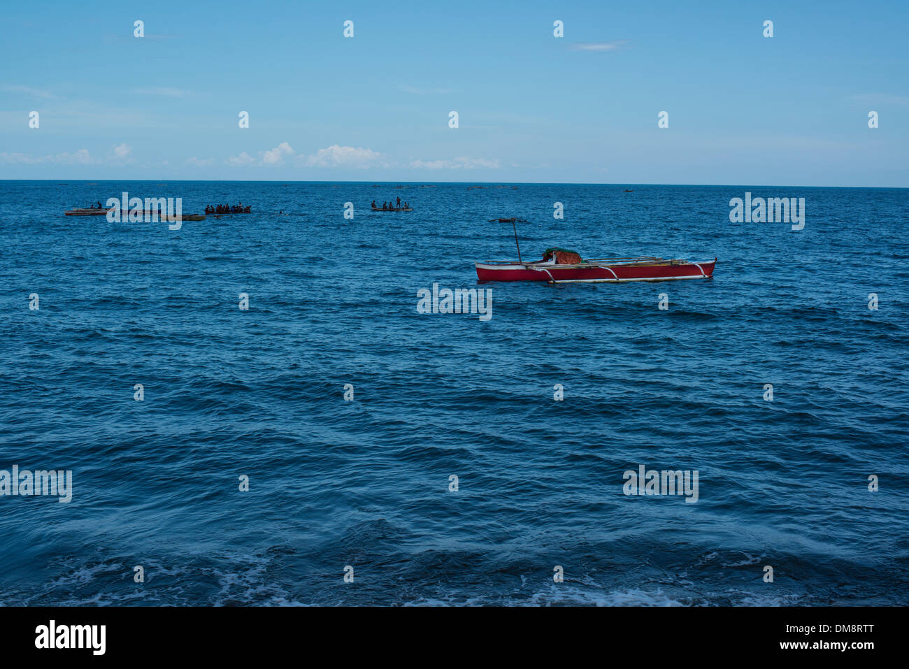 Fishing boats with fishermen gathered together Stock Photo