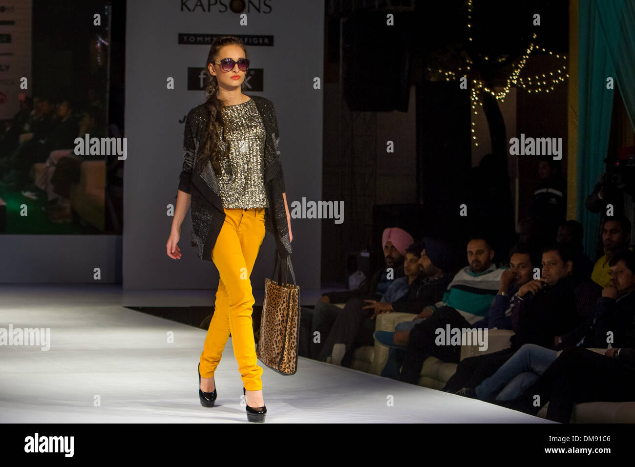 Punjab, Punjab of India. 12th Dec, 2013. A girl displays clothes at a fashion  show in Bathinda, Punjab of India, Dec. 12, 2013. An open-air fashion show  displaying clothes with affordable prices