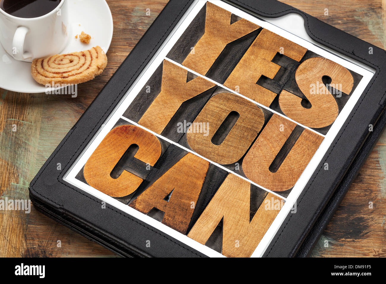 Yes you can - motivational slogan on a digital tablet with a cup of coffee Stock Photo