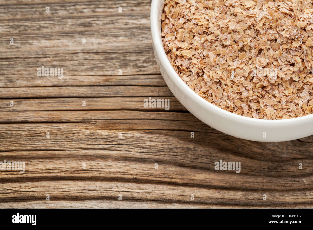 wheat bran - a ceramic bowl on grained wood background Stock Photo - Alamy