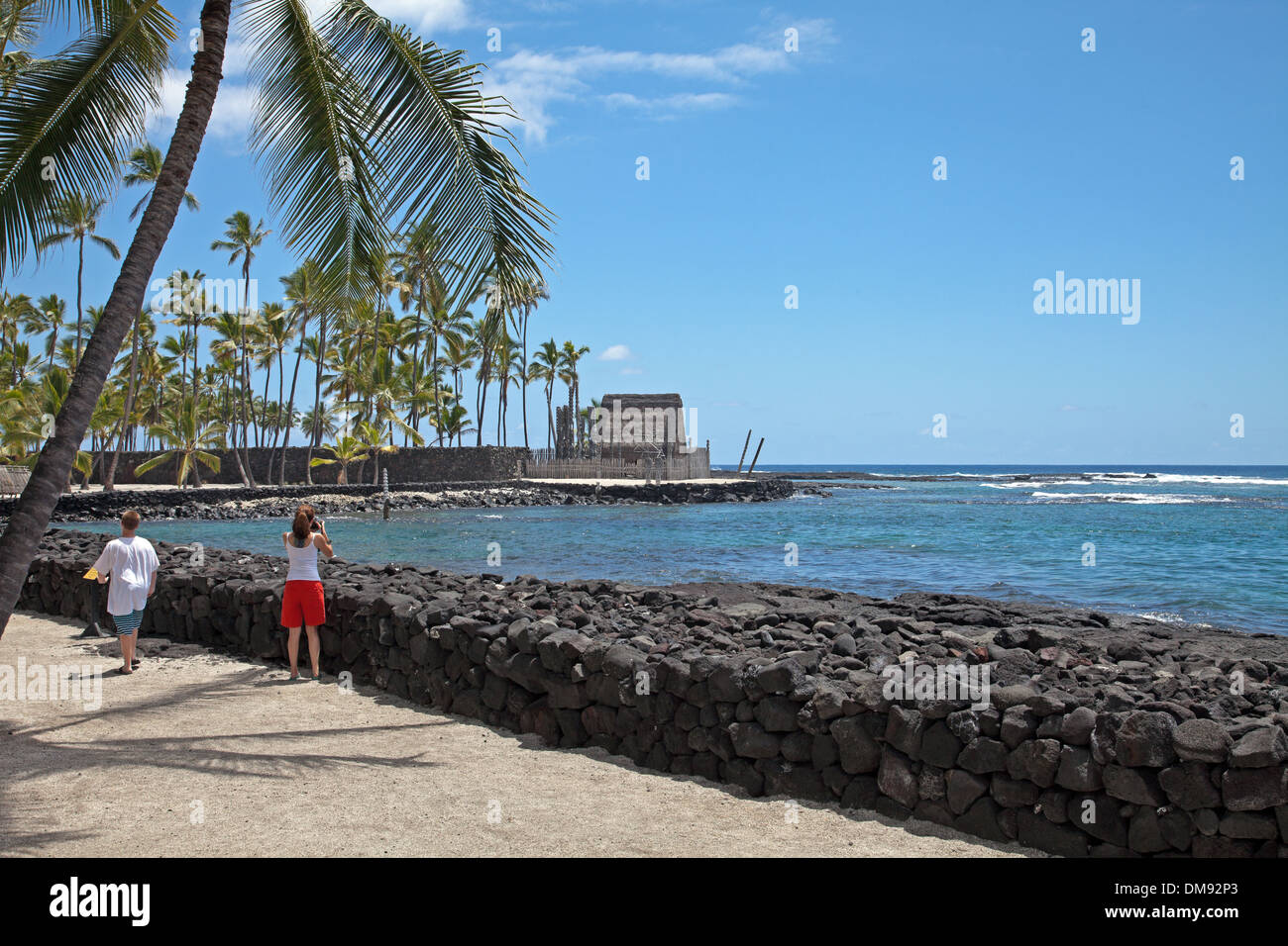Editorial use only. Pu'uhonua o Honaunau National Historical Park -This rebuilt temple and mausoleum (Hale o Keawe) in distance. Stock Photo