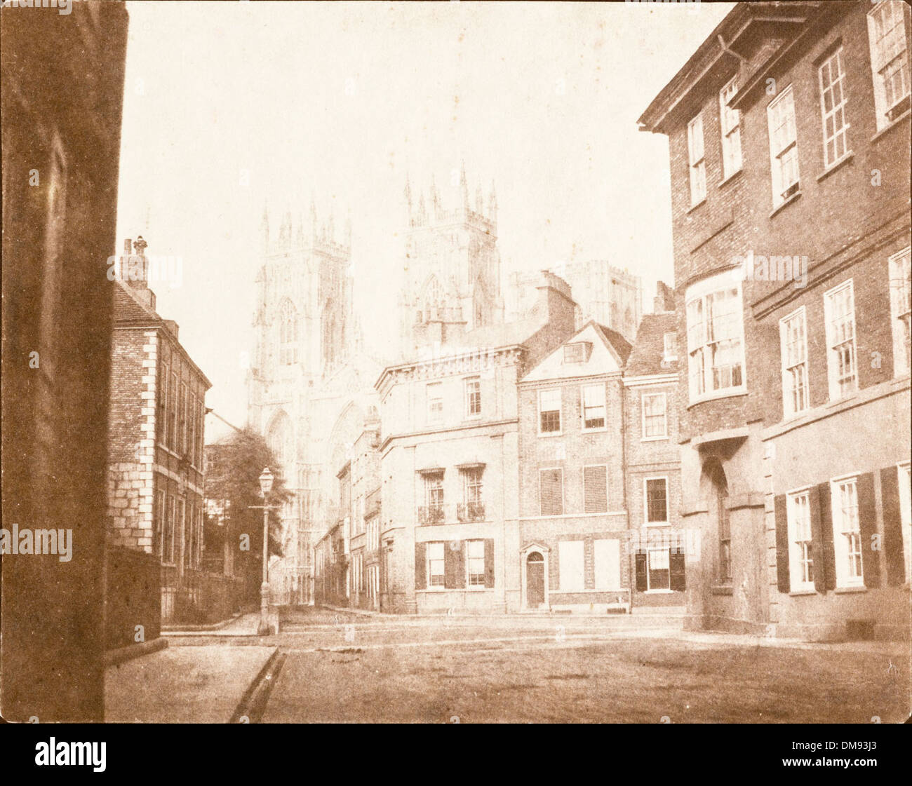 This image shows the view of York Minster Cathedral as seen from Lod Lane. The view captures the grandeur of the cathedral's architecture and its cultural importance in the city of York, offering a historical perspective of this iconic landmark. Stock Photo