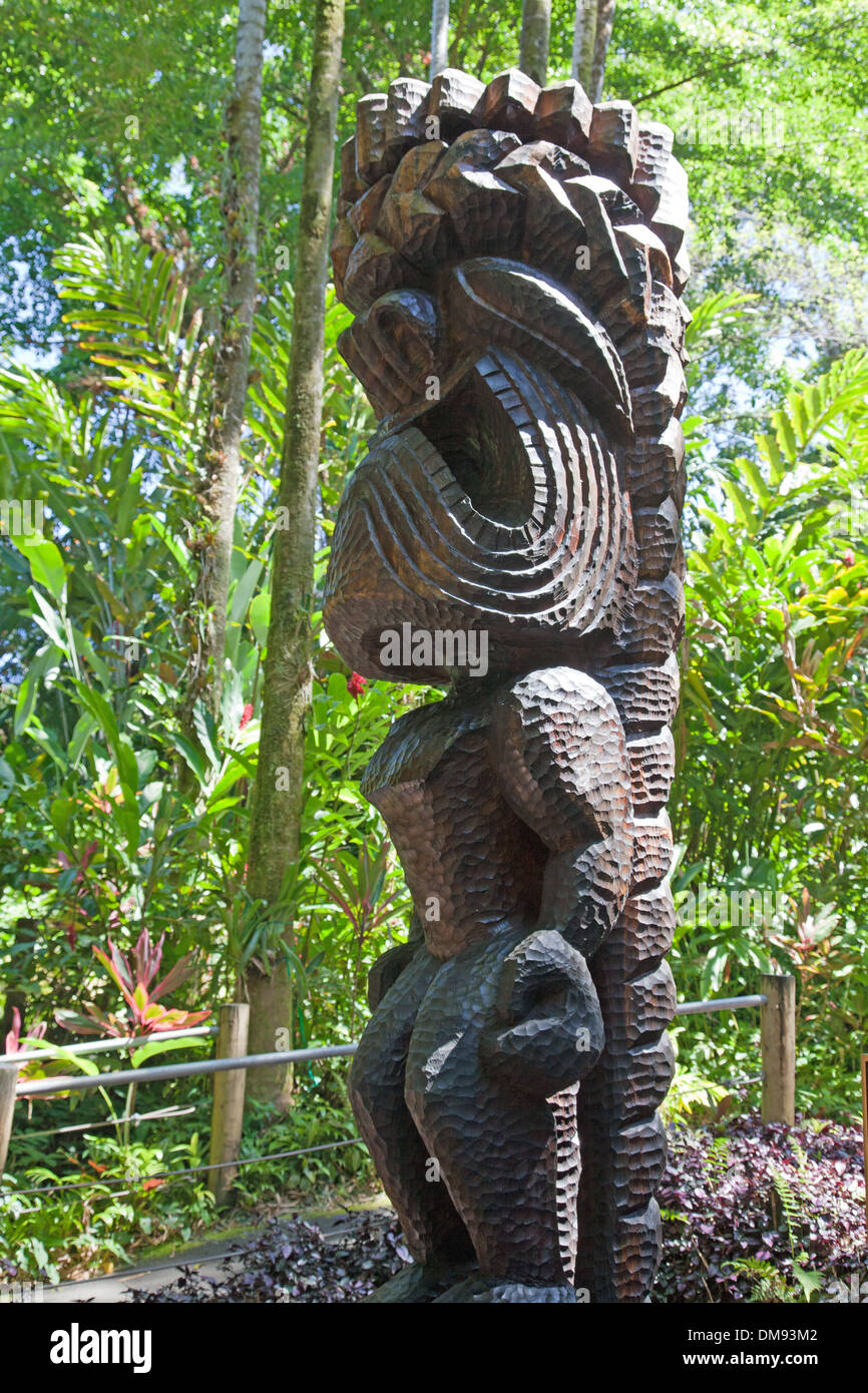 A carved wooden statue of the Hawaiian god Ku centers the banyan canyon