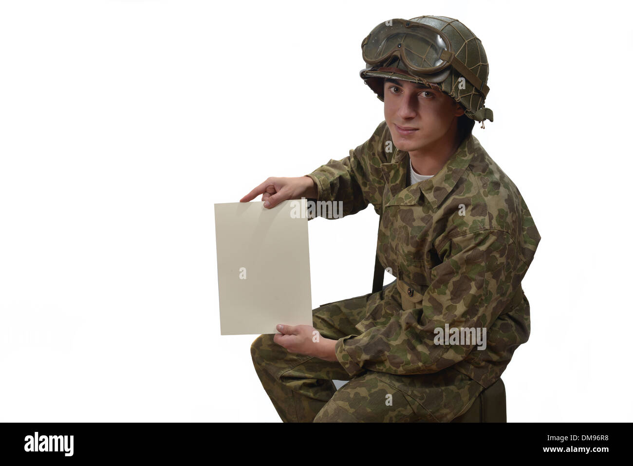young American soldier in camouflage uniform shows a letter Stock Photo