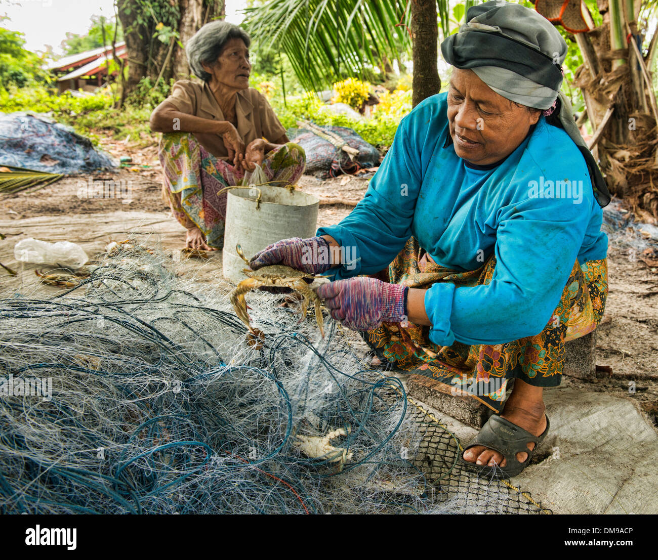 cleaning the fishing nets in the crab market on Koh Sukorn island in