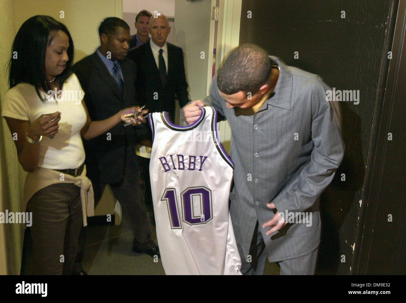 Mike Bibby gets his uniform from Stephanie Shepard from Kings Media  relations. Mike was entering Arco Arena for his press conference. It was  the first chance the media had to talk with