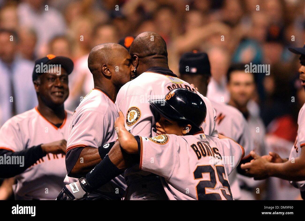 San Francisco Giants slugger Barry Bonds is embraced by Giants teammate