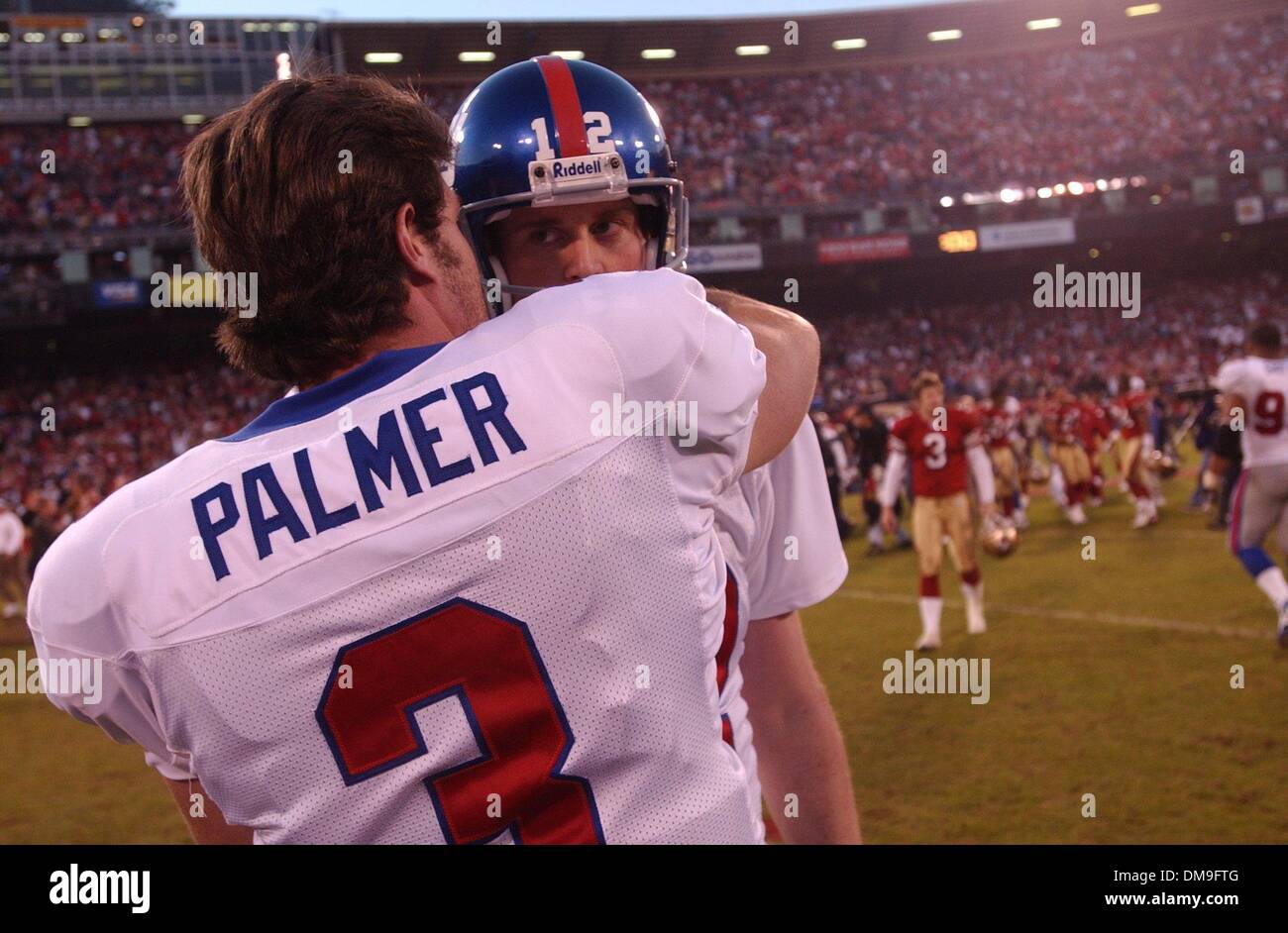 Giants placeholder Matt Allen is consoled at the end of the game by QB Jesse Palmer after Allen fumbled the field goal snap to lose the game in the NFC Wild Card Game between the San Francisco 49ers and the New York Giants, Sunday January 5, 2003 at Candlestick Park. Sacramento Bee photograph by Hector Amezcua./ZUMA Press Stock Photo