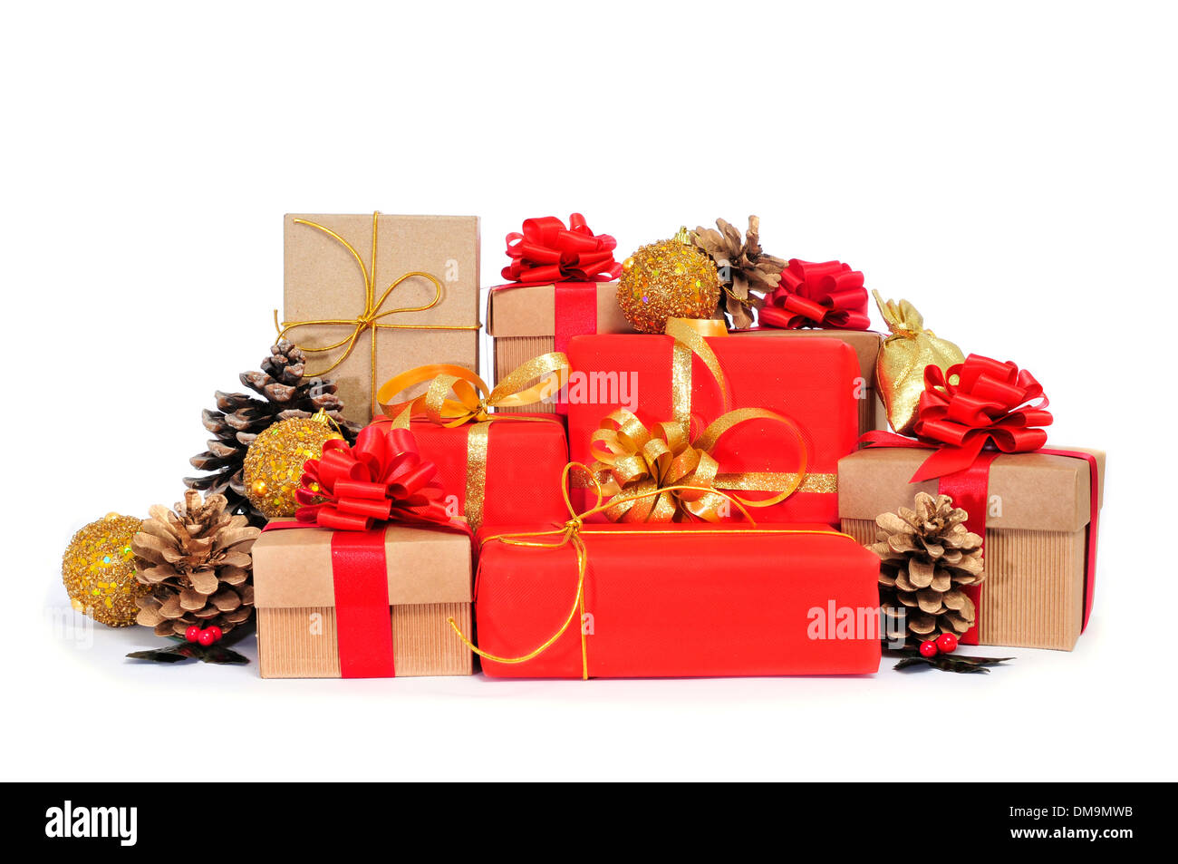 some christmas gifts wrapped with wrapping paper of different colors and ribbon bows, and some christmas ornaments on a white ba Stock Photo