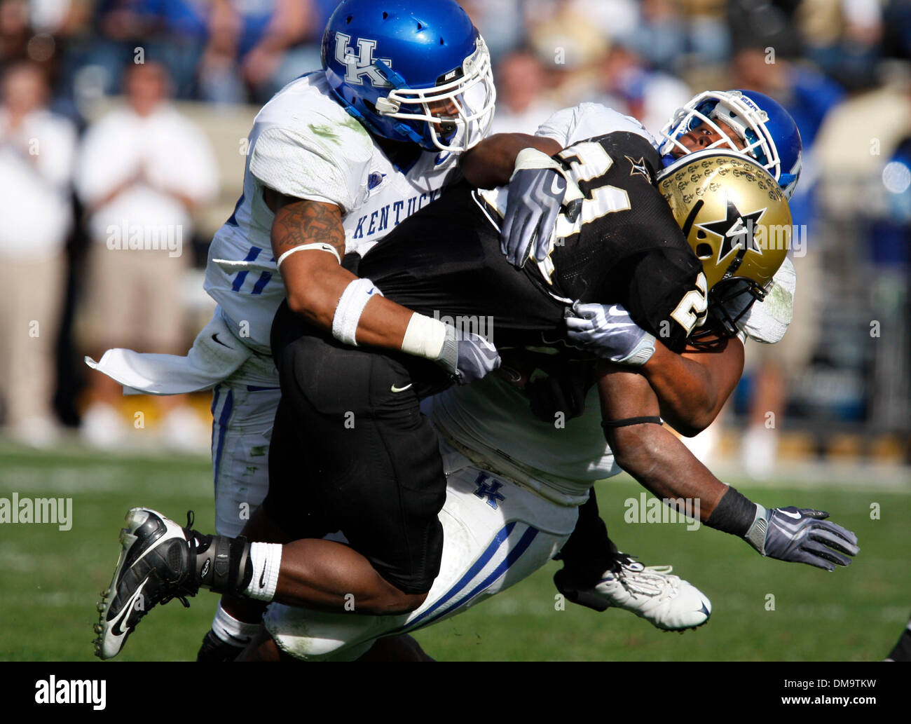 UK's Calvin Harrison,left, and Sam Maxwell brought down Vandy's Zac Stacy on third down, forcing a punt in the third quarter of the University of Kentucky vs. Vanderbilt football game  on Saturday, Nov. 14, 2009 in Nashville, Tennessee.   Photo by David Perry | Staff  (Credit Image: © Lexington Herald-Leader/ZUMApress.com) Stock Photo