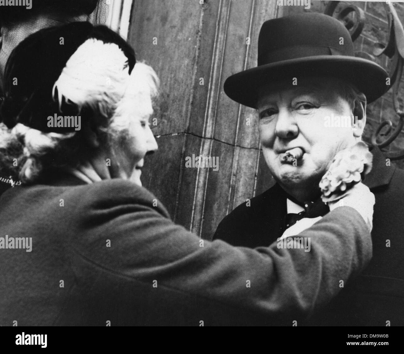 Apr. 21, 1953 - London, England, U.K. - SIR WINSTON CHURCHILL (1874-1965) was a British politician and statesman who served as Prime Minister of the United Kingdom. PICTURED: Churchill receives an emblem from Mrs. Roberts outside of No. 10 Downing Street for subscribing to the Geranium Fund. (Credit Image: © KEYSTONE Pictures USA) Stock Photo