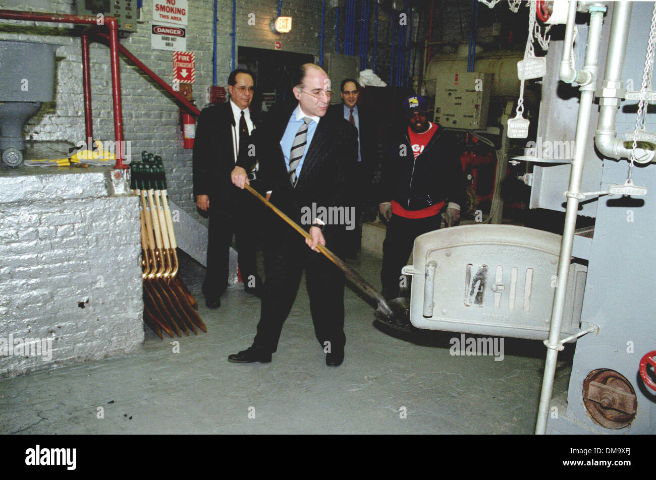 Mar. 23, 2001 - Queens, NY, USA - 3/23/01 Queens NY Schools Chancellor Harold Levy shovels coal into the last coal burning school in Queens, The Queens Academy in Flushing, which is scheduled for a more modern heating system. The school dates back to 1897. ( Neil Schneider).Â© NEIL SCHNEIDER/(Credit Image: © Globe Photos/ZUMAPRESS.com) Stock Photo