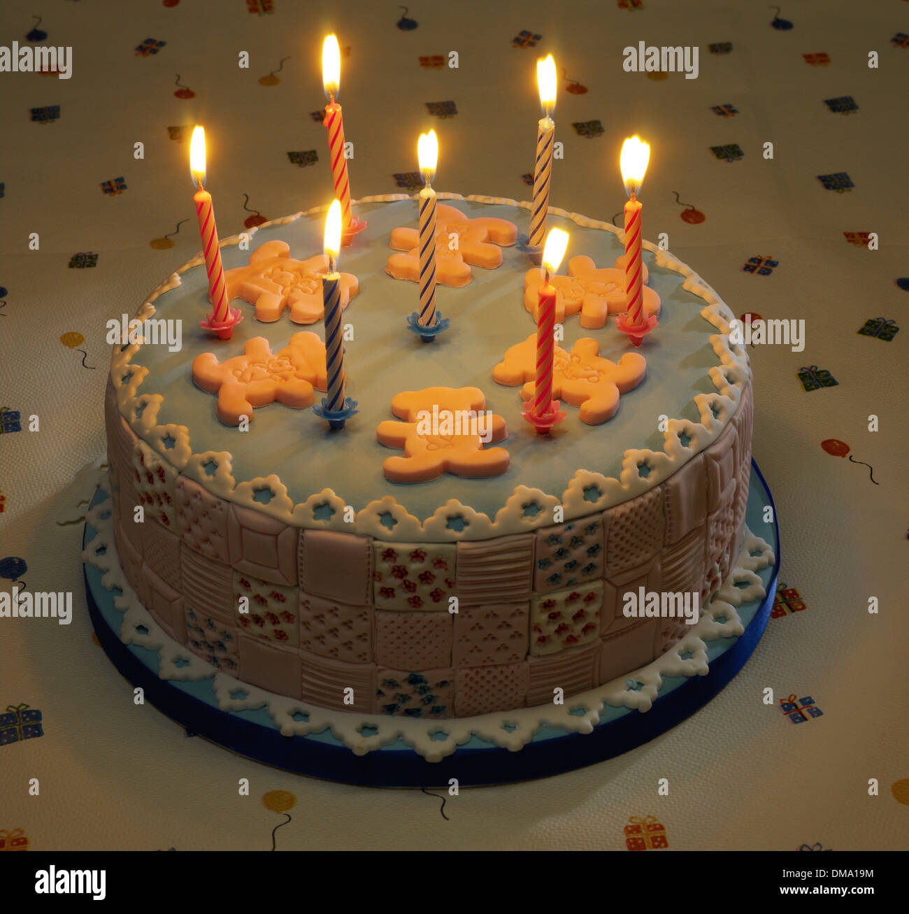 Birthday cake candles lit Stock Photo - Alamy