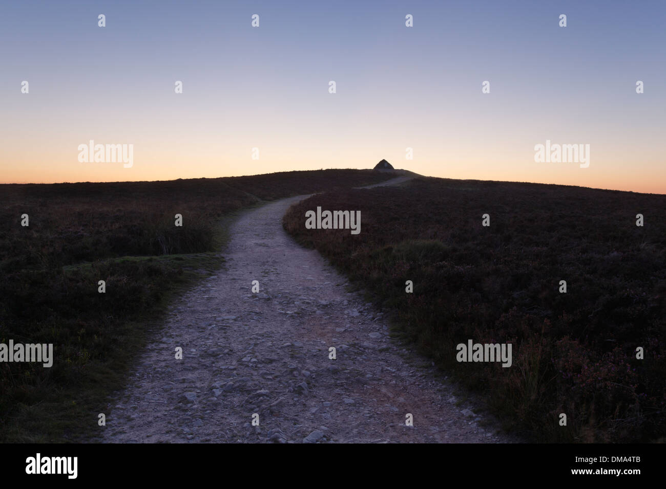 Path approaching Cairn on the summit of Dunkery Beacon at Dusk. Exmoor National Park. Somerset. England. UK. Stock Photo