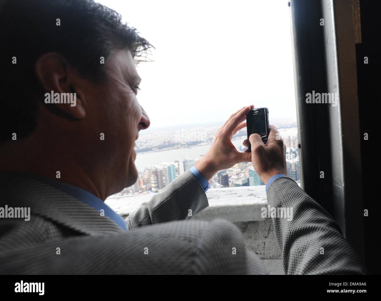 Nov 04, 2009 - Manhattan, New York, USA - TINO MARTINEZ taking a cell phone picture of Yankee Stadium from the 103rd floor parapet. New York Yankee great and four-time World Series champion Tino Martinez lights and tours the Empire State Building to wish the Bronx Bombers good and celebrate the playing of Game 6 against the Philadelphia Phillies at Yankee Stadium tonight.  (Credit  Stock Photo