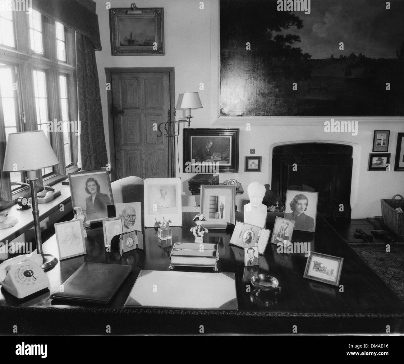 June 22, 1966 - Westerham, Kent, U.K. - Sir Winston Churchill's home Chartwell will be opened to the public for part of 1966. It was bought by a group of friends and presented to the National Trust. PICTURED: A table in Churchill's study with family portraits. (Credit Image: © KEYSTONE Pictures USA) Stock Photo