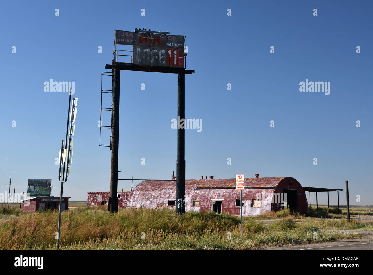 Abandoned roadside cafe sign and tumbledown barn on old Route 66 Stock Photo