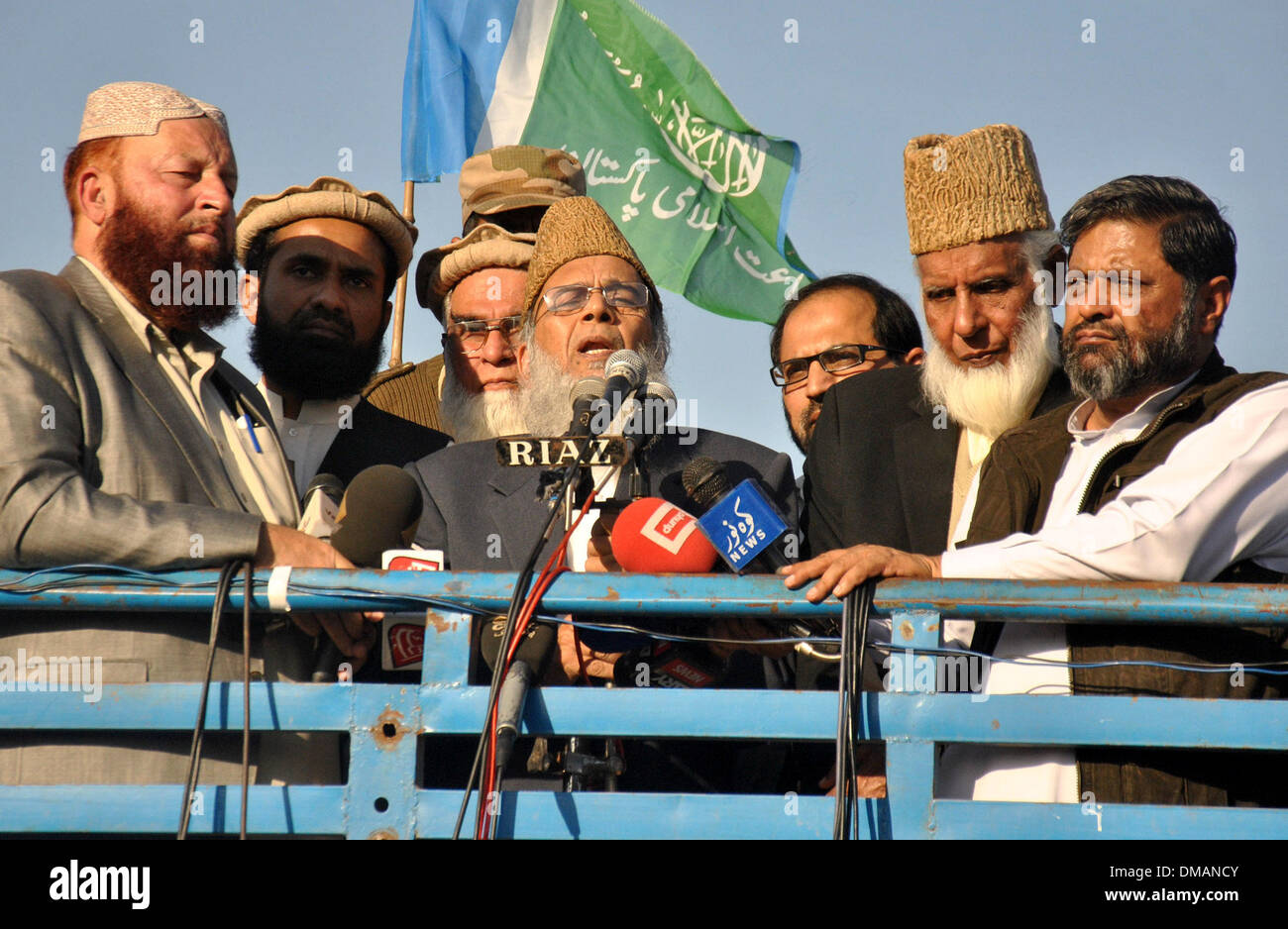 Lahore, Pakistan. 13th Dec, 2013. Syed Munawar Hassan (C), head of Jamaat-e-Islami Pakistan, addresses supporters during a protest rally to condemn execution of Bangladeshi Islamist leader Abdul Quader Molla in eastern Pakistan's Lahore, on Dec. 13, 2013. Bangladesh has executed Abdul Quader Molla, an Islamist party leader convicted of war crimes in 1971, which is the first execution of a war criminal in the country. In protest against Molla's execution, his party Jamaat called countrywide dawn-to-dusk general strike for Sunday. Credit:  Sajjad/Xinhua/Alamy Live News Stock Photo