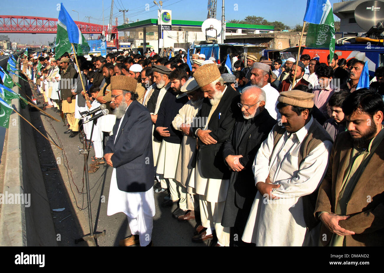 Lahore, Pakistan. 13th Dec, 2013. Activists of Jamaat-e-Islami party offer prayers for Bangladeshi Islamist leader Abdul Quader Molla a day after his execution in eastern Pakistan's Lahore, on Dec. 13, 2013. Bangladesh has executed Abdul Quader Molla, an Islamist party leader convicted of war crimes in 1971, which is the first execution of a war criminal in the country. In protest against Molla's execution, his party Jamaat called countrywide dawn-to-dusk general strike for Sunday. Credit:  Sajjad/Xinhua/Alamy Live News Stock Photo